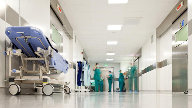 A hospital room being cleaned